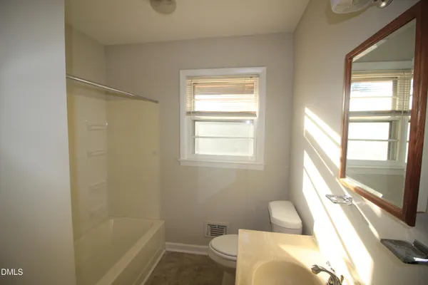 a bath room with a window and a bath tub