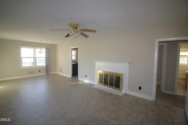 a view of empty room with a fireplace