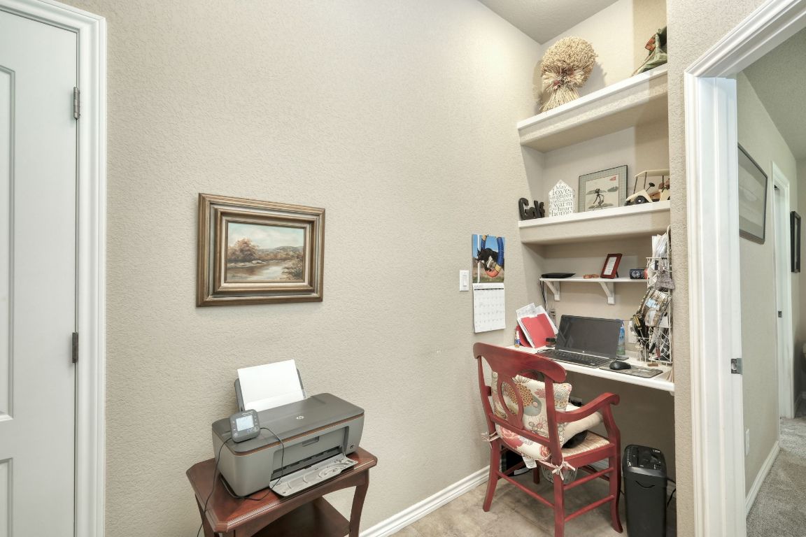 102 Texas Traditions Georgetown, TX 78628 - Photo 15 of 32 a room that has a couch and a workspace