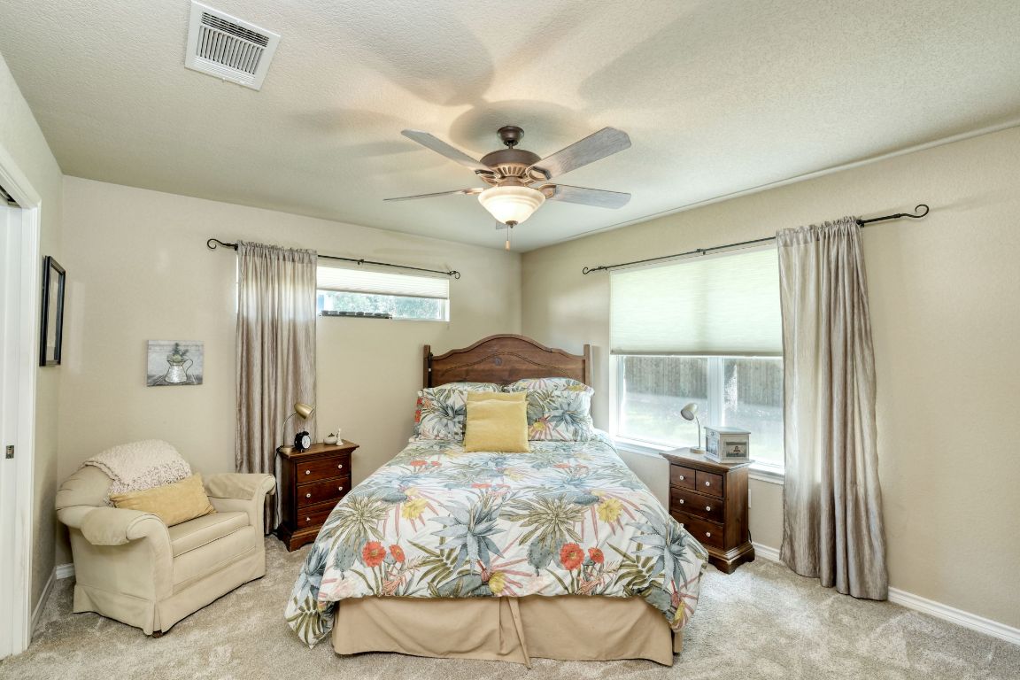 102 Texas Traditions Georgetown, TX 78628 - Photo 16 of 32 a bedroom with a bed and ceiling fan