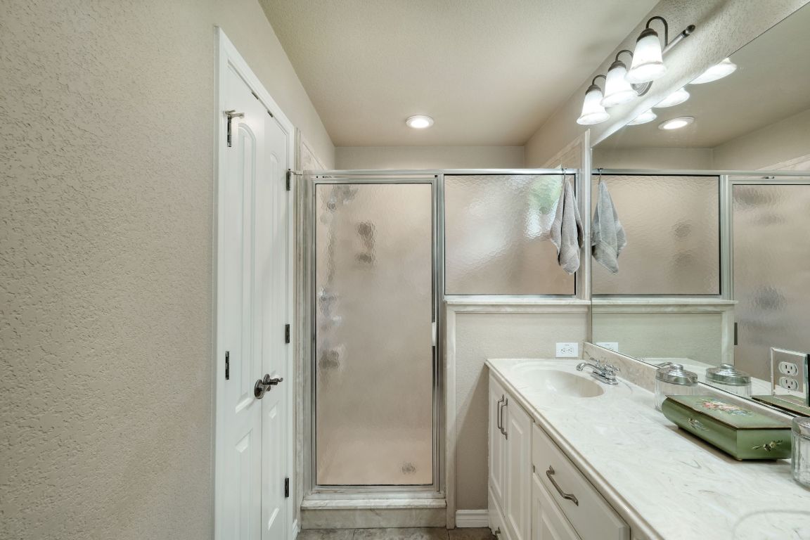102 Texas Traditions Georgetown, TX 78628 - Photo 18 of 32 a bathroom with a double vanity sink and a mirror