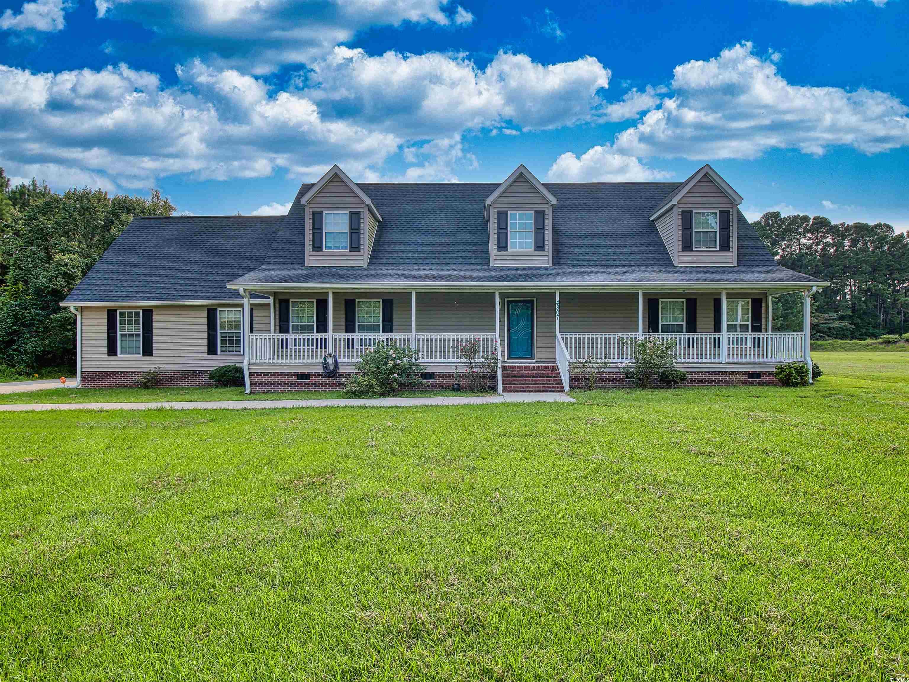 Cape cod home featuring crawl space, a porch, roof with shingles, and a front yard