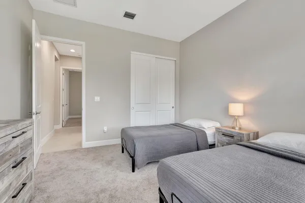 a bedroom with two beds and painted walls