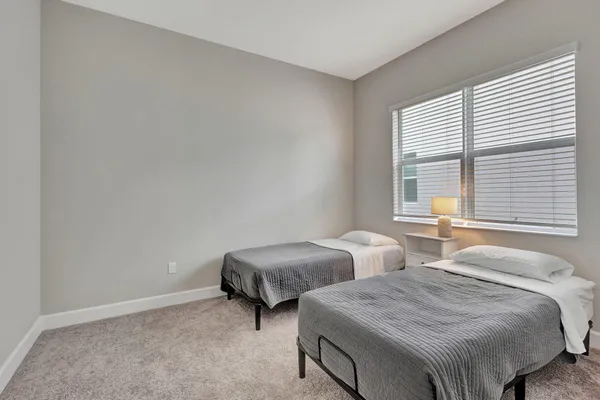 a bedroom with two beds and a window