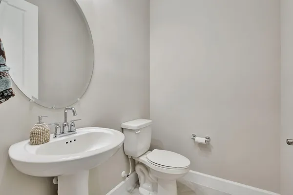 a bathroom with a sink a toilet and mirror