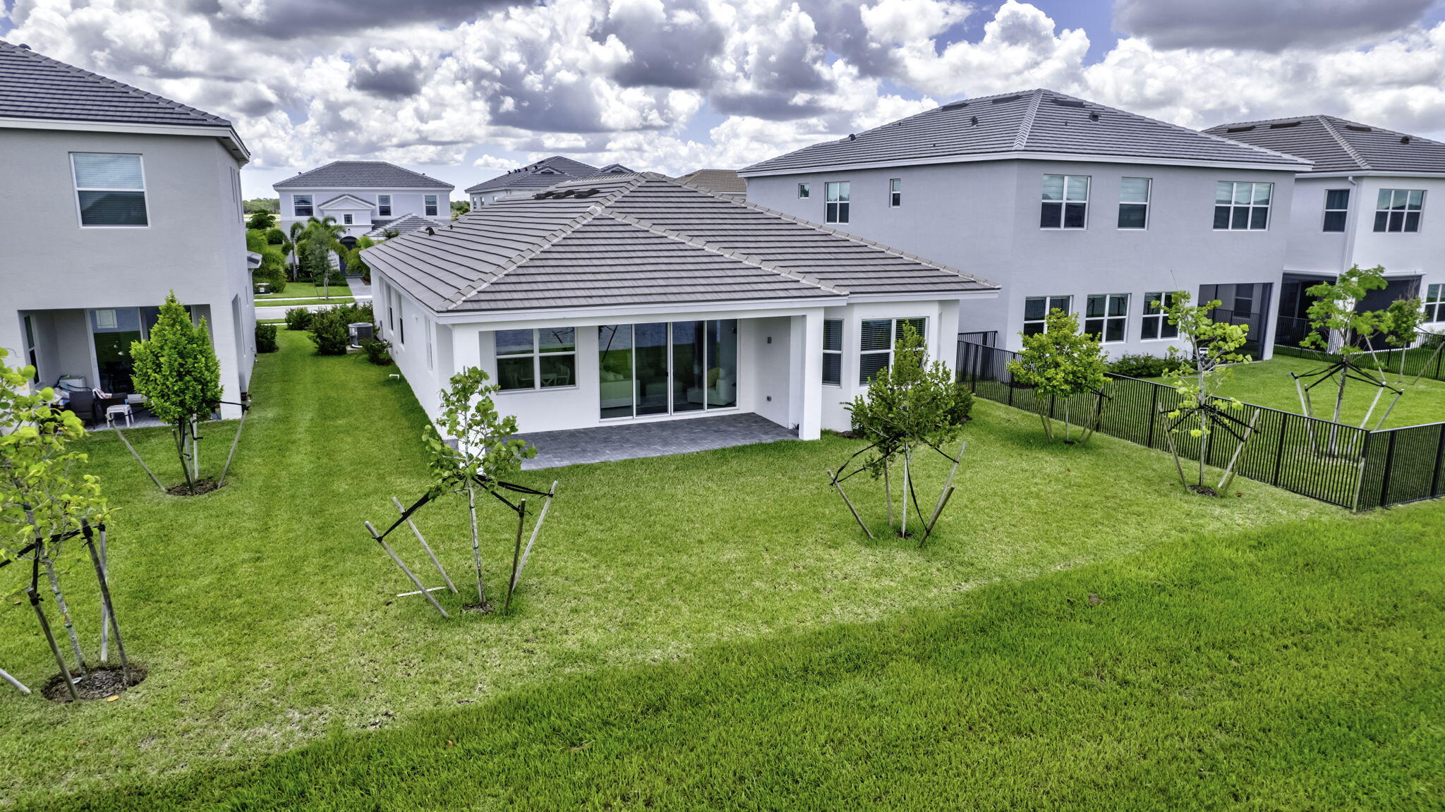 5403 Macoon Way Westlake, FL 33470 - Photo 3 of 51 a view of house with a yard patio and a garden
