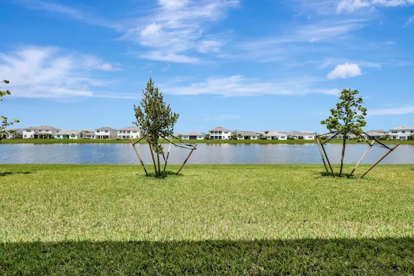 a view of a lake with houses in the back