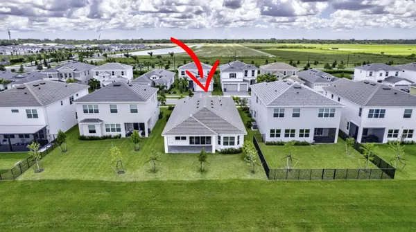 aerial view of a house with a big yard