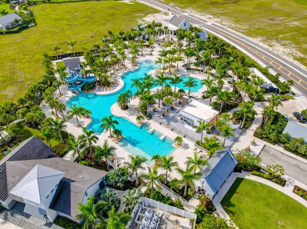 an aerial view of residential houses with outdoor space and swimming pool