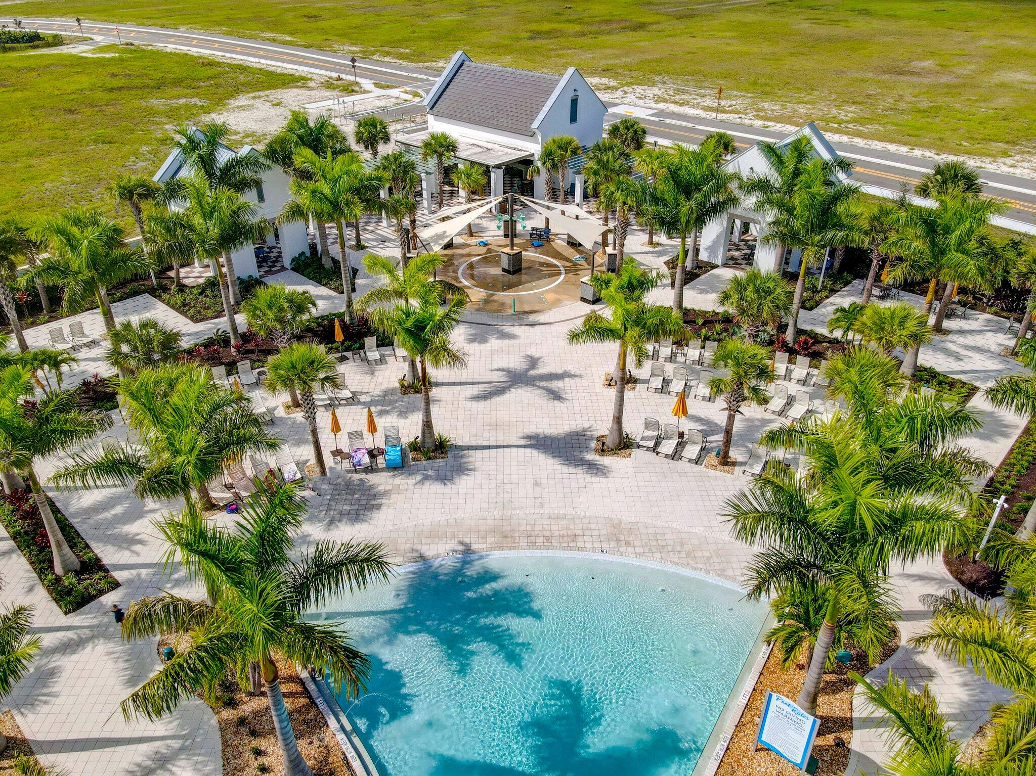 5403 Macoon Way Westlake, FL 33470 - Photo 44 of 51 a view of a swimming pool with lawn chairs under an umbrella
