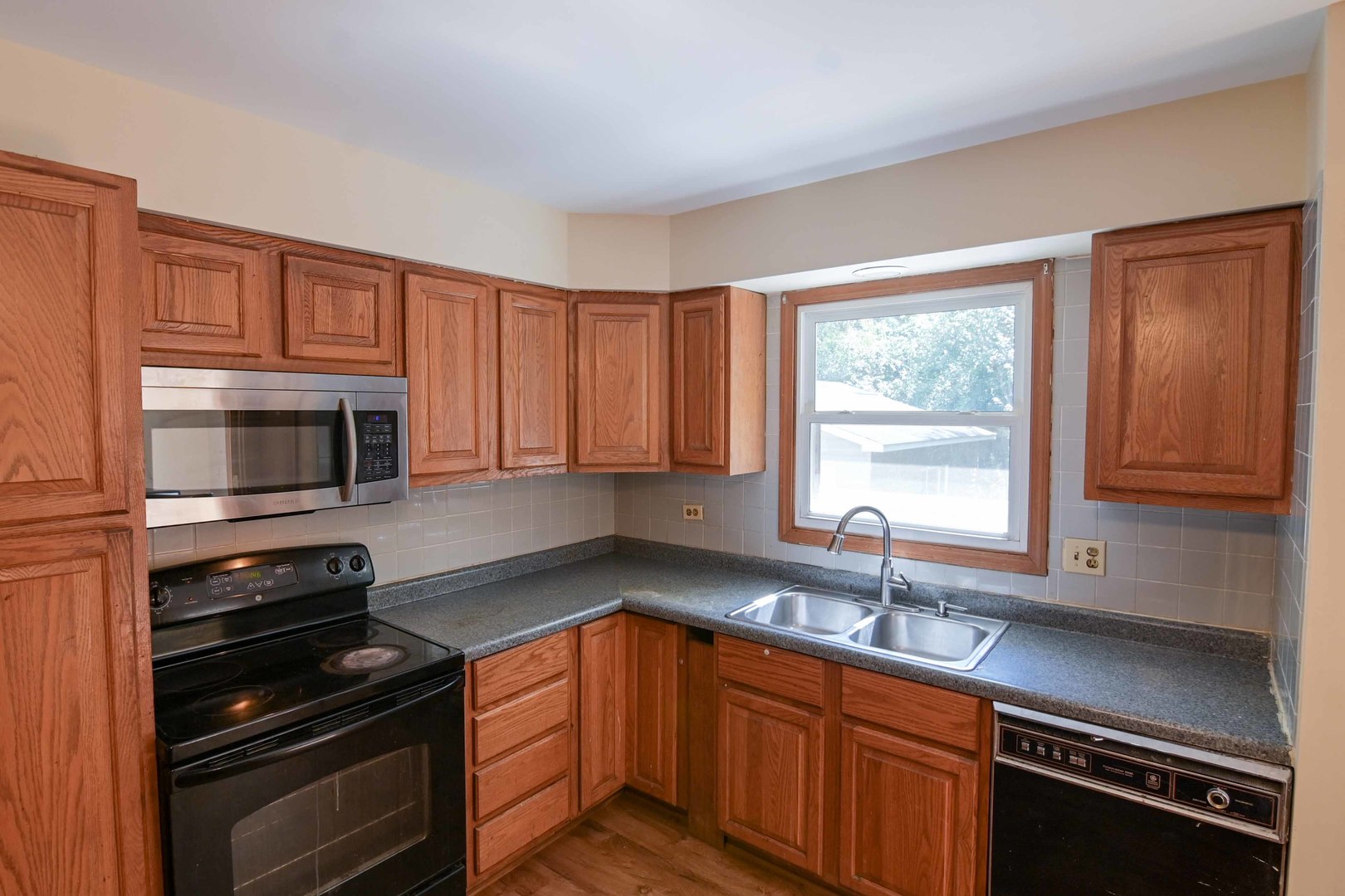 2729 Lowery Court Zion, IL 60099 - Photo 2 of 36 a kitchen with stainless steel appliances a sink stove and microwave
