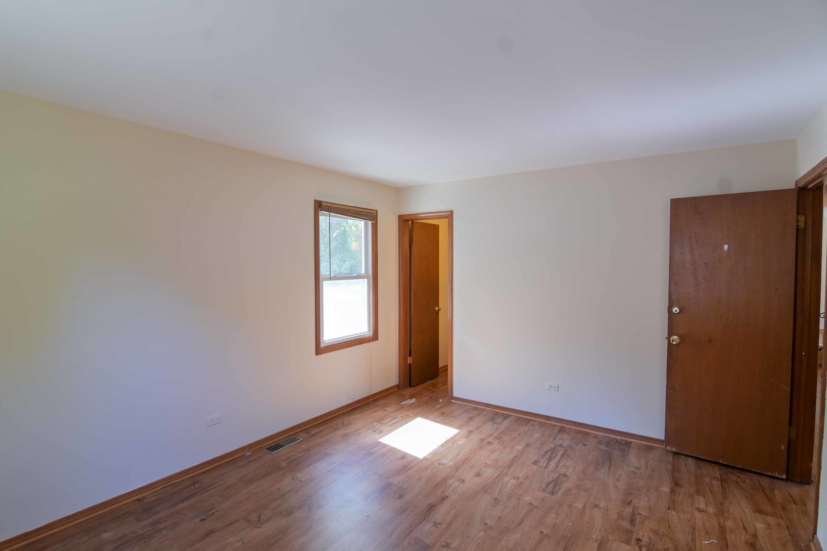 2729 Lowery Court Zion, IL 60099 - Photo 11 of 36 an empty room with wooden floor and windows