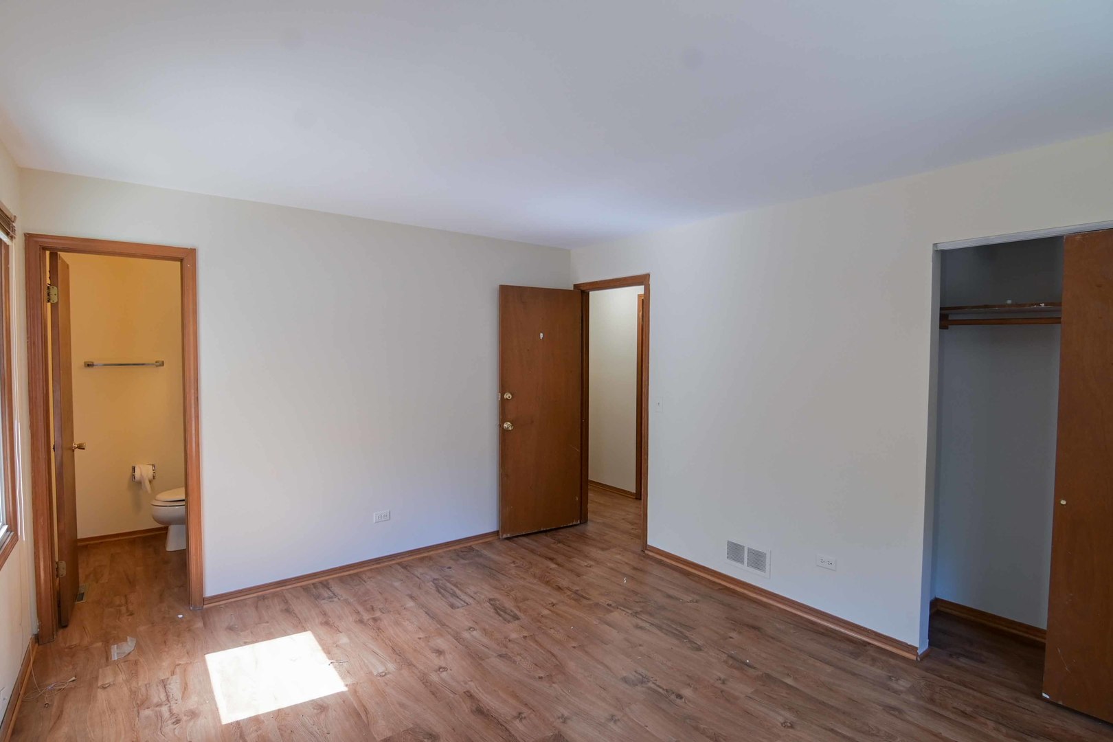 2729 Lowery Court Zion, IL 60099 - Photo 12 of 36 an empty room with wooden floor and windows