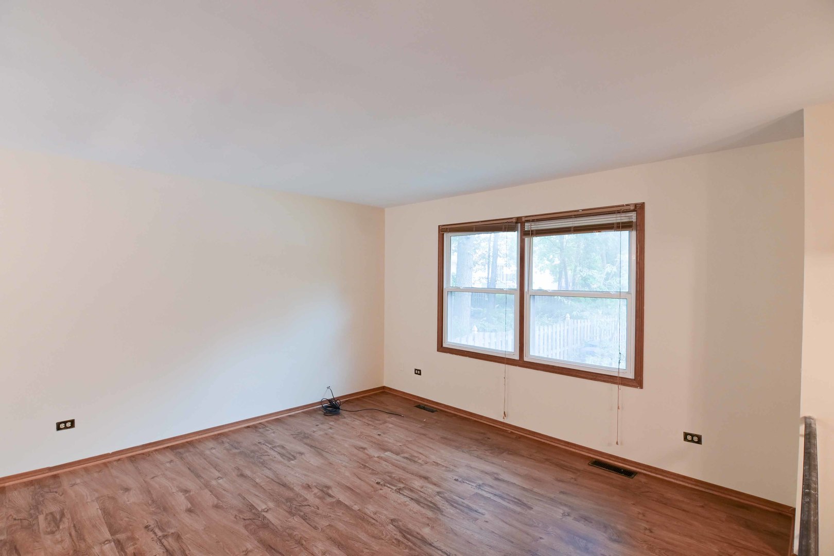 2729 Lowery Court Zion, IL 60099 - Photo 14 of 36 an empty room with wooden floor and windows