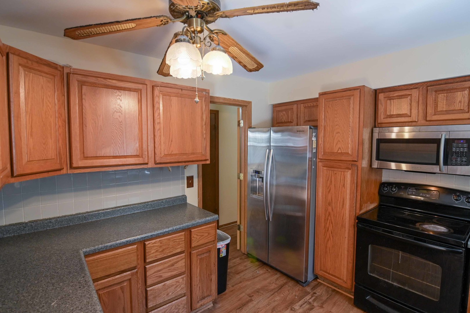 2729 Lowery Court Zion, IL 60099 - Photo 3 of 36 a kitchen with stainless steel appliances a stove a refrigerator and cabinets