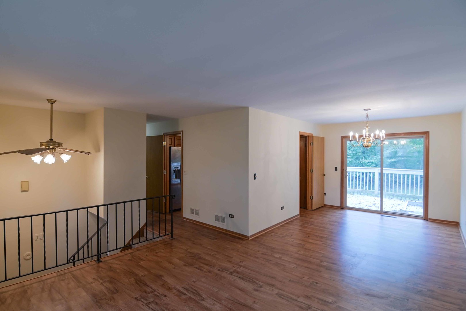 2729 Lowery Court Zion, IL 60099 - Photo 9 of 36 a view of a livingroom with wooden floor and chandelier