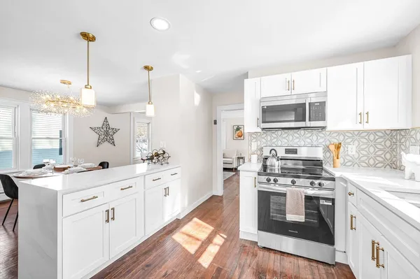 a kitchen with a stove a sink and a microwave
