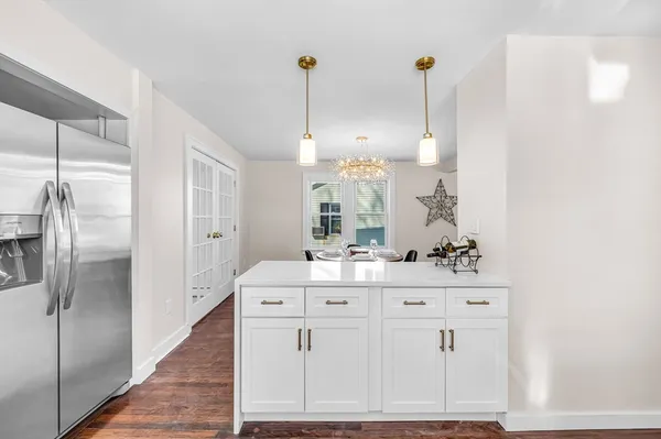 a view of a kitchen with kitchen island a counter top space appliances and cabinets