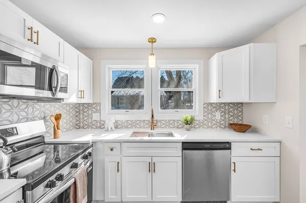 a kitchen with a sink stove and cabinets