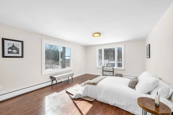 a bedroom with a bed and wooden floor