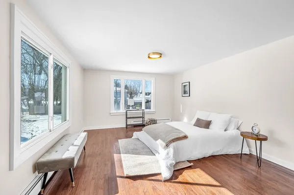 a bedroom with a bed and a large window