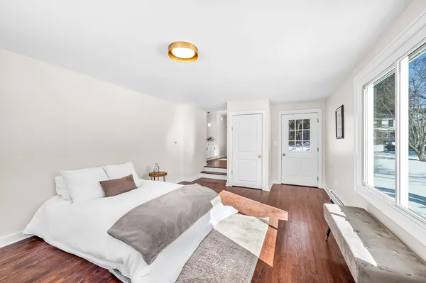 a bedroom with a bed and a large window