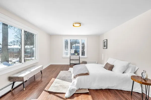 a bedroom with a bed and a large window