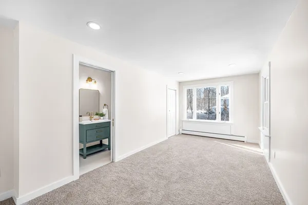 an empty room with windows and closet