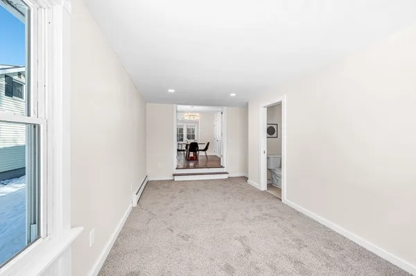 a view of a livingroom and a kitchen with furniture and a hallway