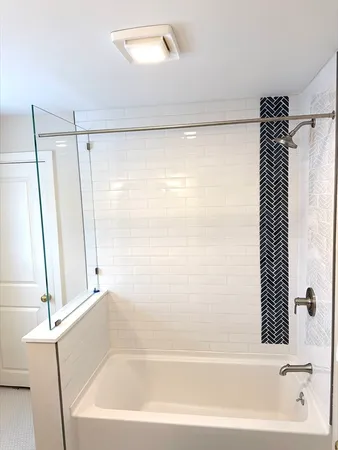 a bathroom with a bathtub and a shower