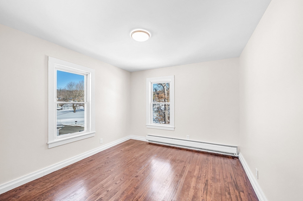 20 Walnut Street Gill, MA 01354 - Photo 31 of 42 an empty room with wooden floor and windows
