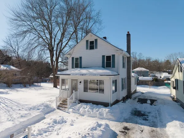a view of a house with snow on the road