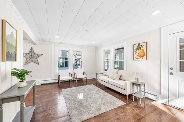 a living room with furniture and wooden floor