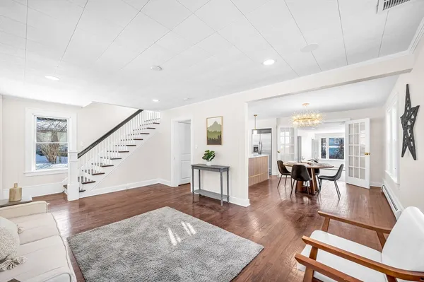 a living room with furniture and wooden floor