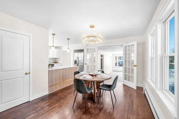 a view of a dining room with furniture window and wooden floor