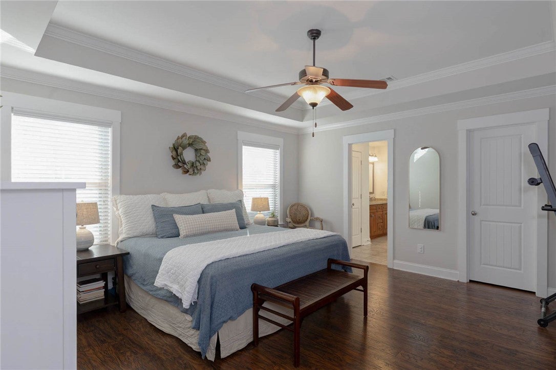 641 Deer Run Road Auburn, AL 36832 - Photo 20 of 28 This primary bedroom offers warm hardwood floors, an inviting tray ceiling, and convenient access to the primary bathroom.