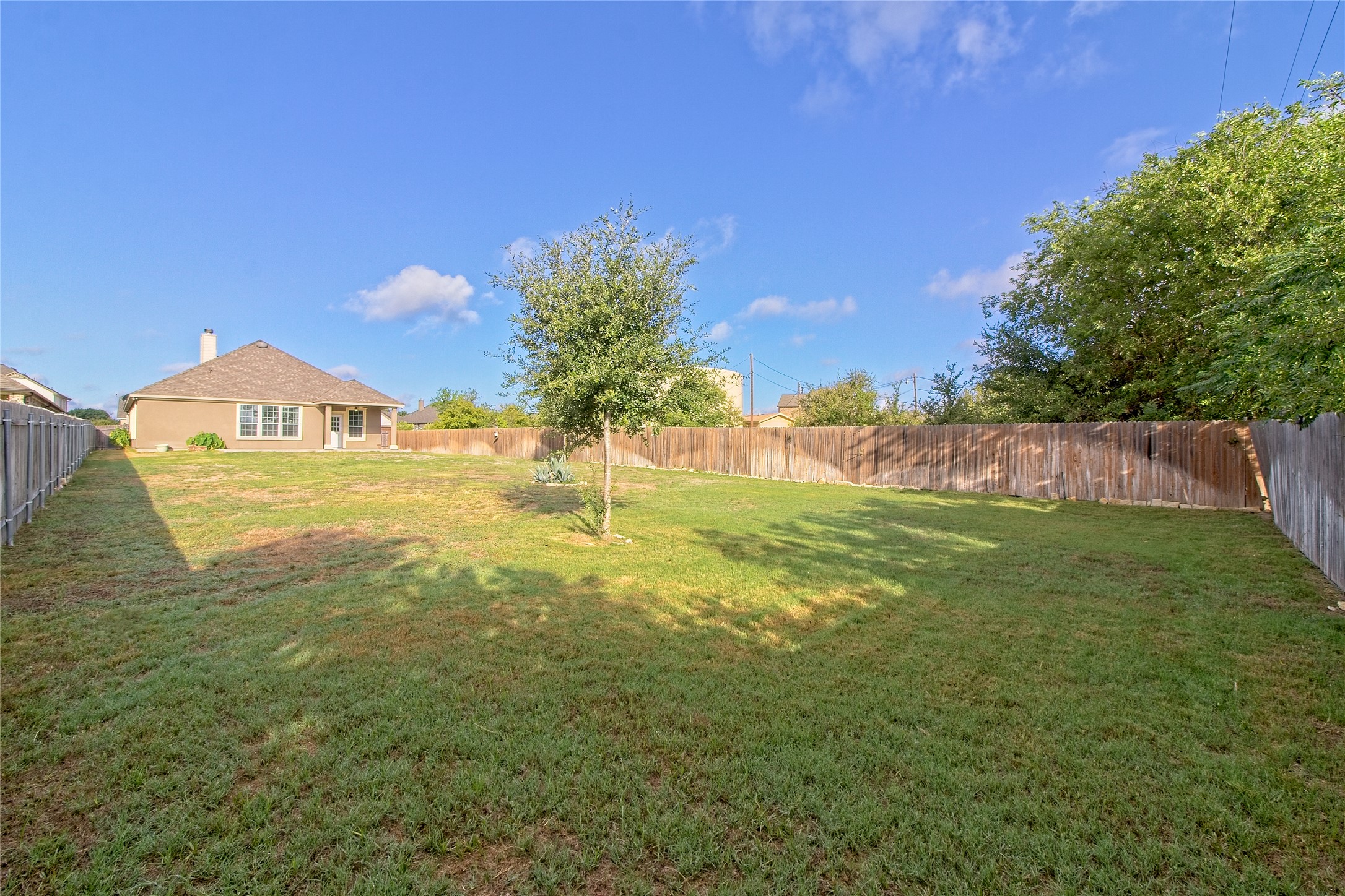 31443 Kingsway Road Georgetown, TX 78628 - Photo 28 of 40 A generously sized yard, fully fenced for privacy, awaits your creative landscaping touches.