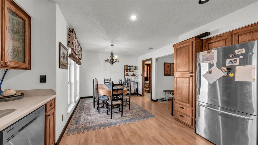 351 Don Propp Road Azle, TX 76020 - Photo 11 of 36 a kitchen with stainless steel appliances a refrigerator and wooden floor