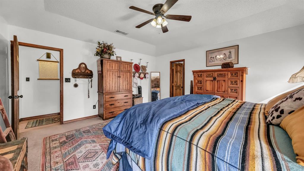 351 Don Propp Road Azle, TX 76020 - Photo 14 of 36 a bed room with a bed and a chandelier