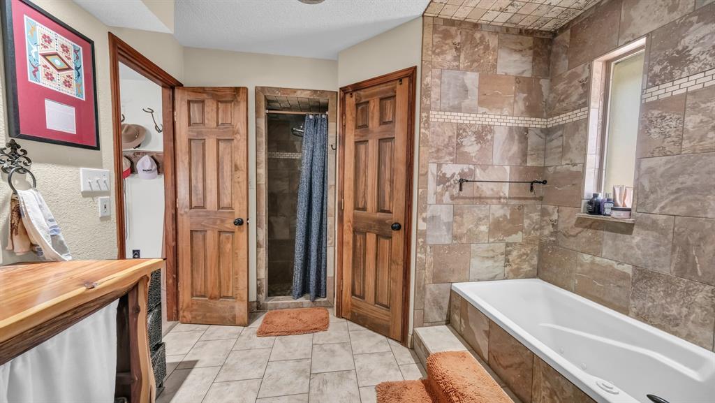 351 Don Propp Road Azle, TX 76020 - Photo 17 of 36 a bathroom with a bathtub and a shower