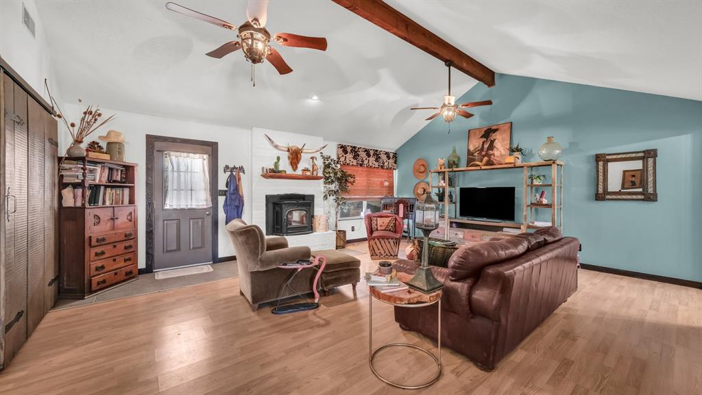 351 Don Propp Road Azle, TX 76020 - Photo 8 of 36 a living room with furniture a flat screen tv and a fireplace