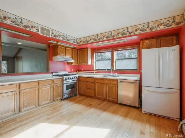 a kitchen with a refrigerator sink and stove