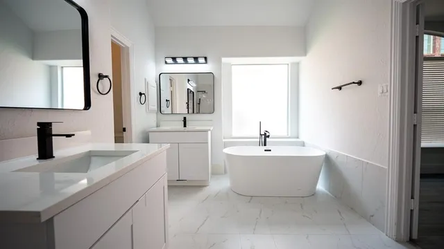 a bathroom with a bathtub sink and mirror