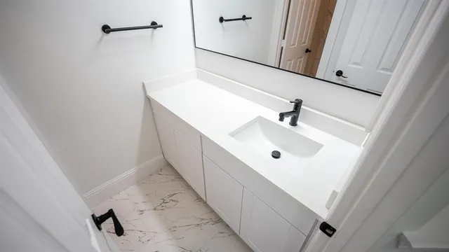a bathroom with a sink and mirror