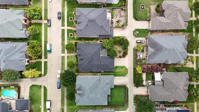 an aerial view of multiple houses with yard