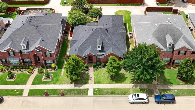 an aerial view of a house with garden space and street view
