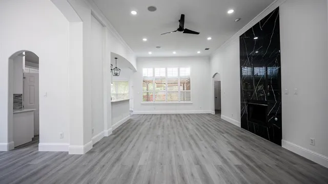 wooden floor in an empty room with a kitchen