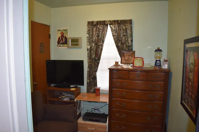 a view of a workspace with furniture and a flat screen tv