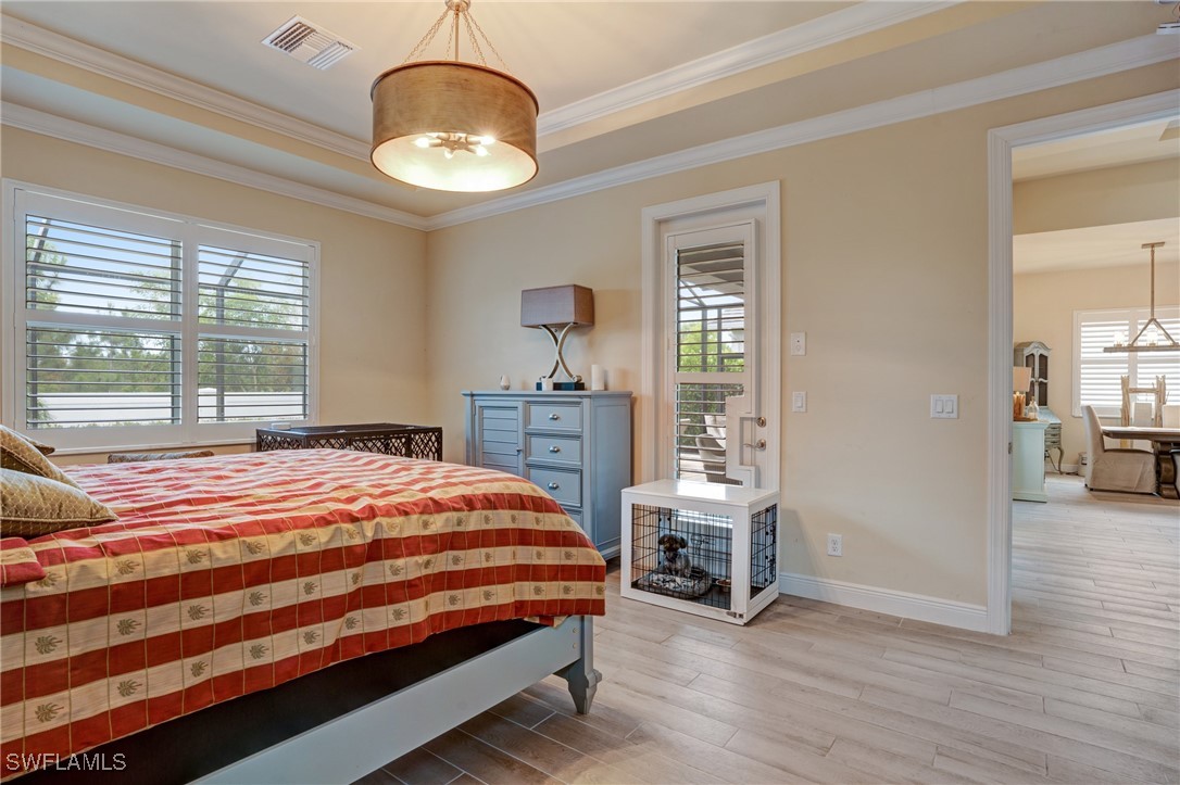 9292 Cayman Drive Naples, FL 34114 - Photo 14 of 50 a bedroom with a bed and a large window