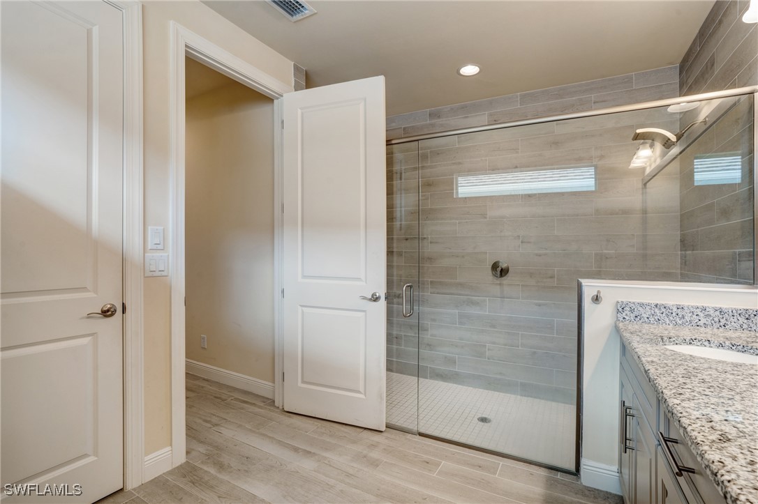 9292 Cayman Drive Naples, FL 34114 - Photo 17 of 50 a bathroom with a shower and mirror